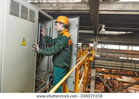 electrician builder engineer switching actuator equipment in distribution fuse box at factory