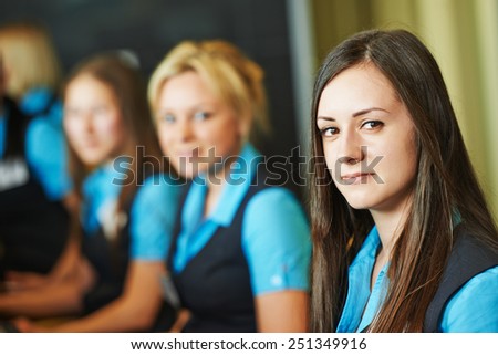 Happy female receptionist worker standing at hotel counter