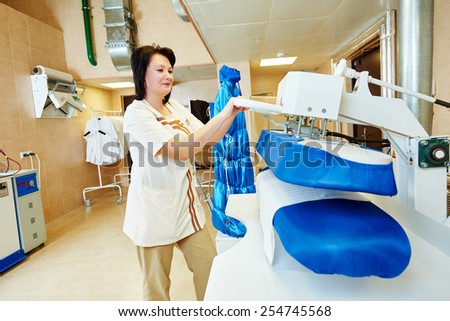 cleaning services. Woman with ironing machine working at hotel