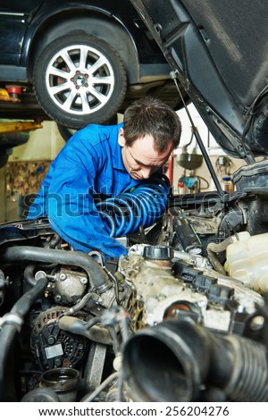 auto repairman mechanic portrait in car auto repair or maintenance shop service station