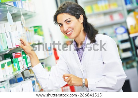 portrait of cheerful female pharmacist chemist woman in pharmacy drugstore
