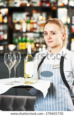 Waitress with menu at the indoor restaurant service