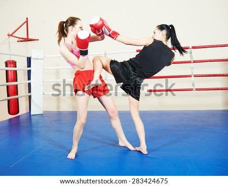 muai thai women fighting at training boxing ring