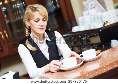 barista woman serving tea at the restaurant bar desk