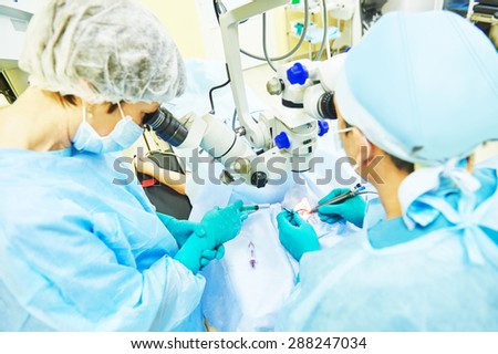 surgeon team in uniform in front of eye vision surgery operation room at medical clinic. selective focus - on operation area