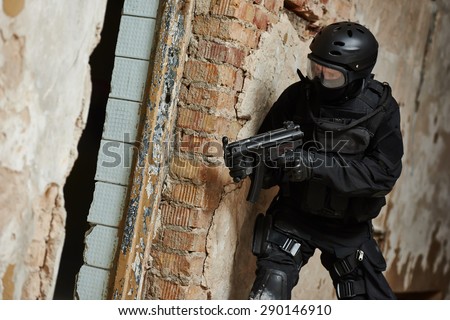 Military industry. Special forces or anti-terrorist police soldier,  private military contractor armed with weapon during clean-up operation, mission