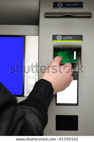 Cash withdrawal. Woman\'s hand inserting plastic card Visa into the ATM