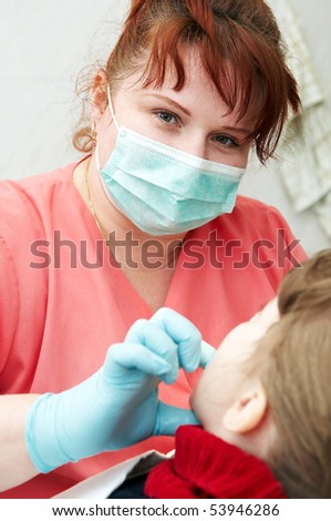 orthodontic doctor examine teeth and gums of little girl jaw
