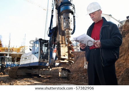builder inspector worker at construction site with documentation