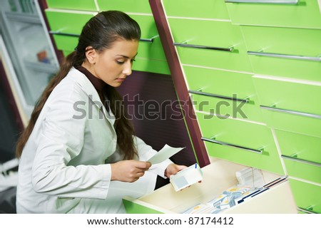 pharmacist chemist woman looking for medicine in pharmacy drugstore with recipe