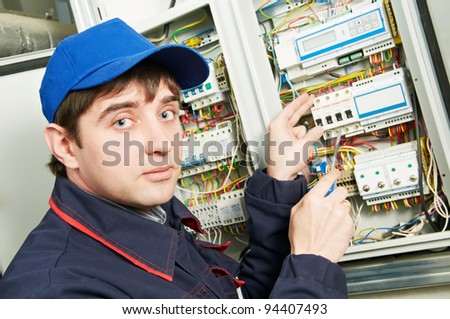 One electrician working on a industrial panel mounting and assembling new wiring