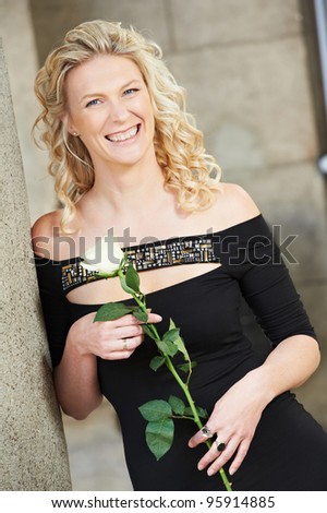 Happy serenity woman at street with flower