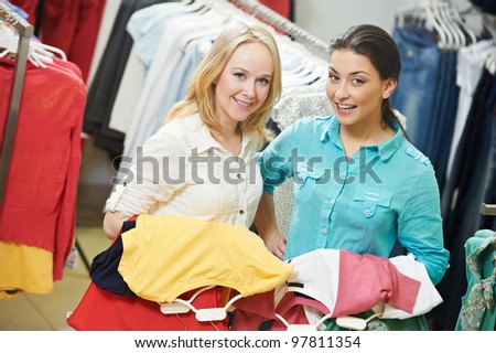Two Young women with apparel shirt or blouse during garments clothing shopping at store