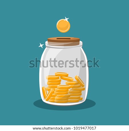 Money box glass jar filled with gold coins cash. Save money.