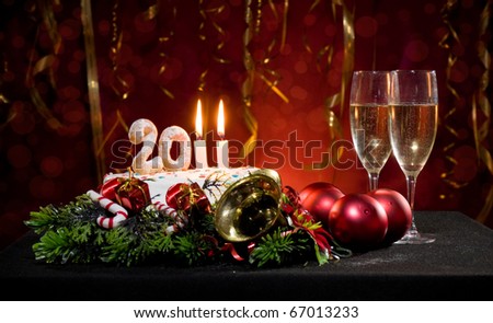 New Year\'s Eve with a cake with candles and other Christmas decorations