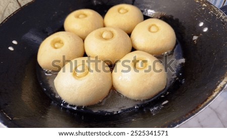 Similar – Image, Stock Photo Cooking doughnuts process. Homemade dough and deep-fried donuts, top view