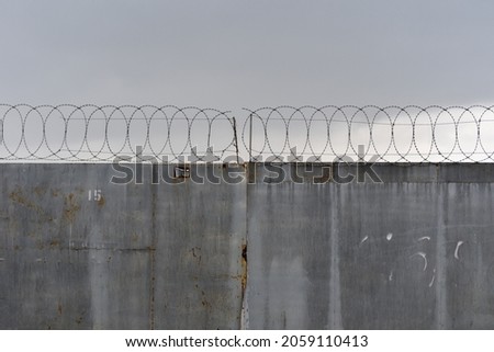 Similar – Image, Stock Photo barbed wire and concrete military fence on the beach near the sea in Crimea