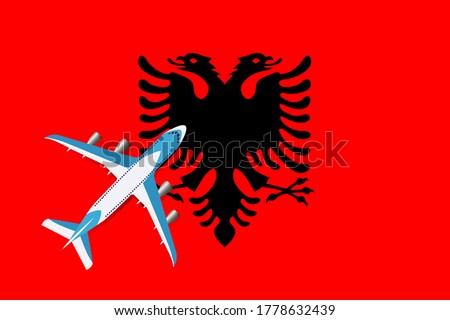 Plane and flag of Albania. Travel concept for design. Concept of tourism and travel.