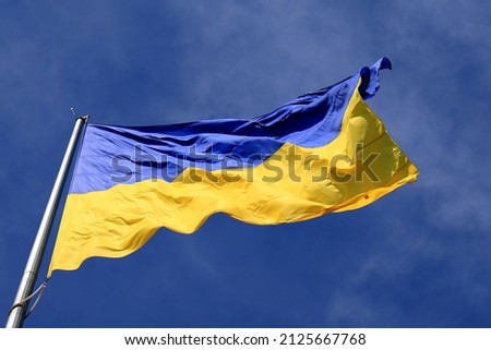 Ukraine flag large national symbol fluttering in blue sky. Large yellow blue Ukrainian state flag, Dnipro city, Independence Constitution Day, National holiday.  Stockfoto © 