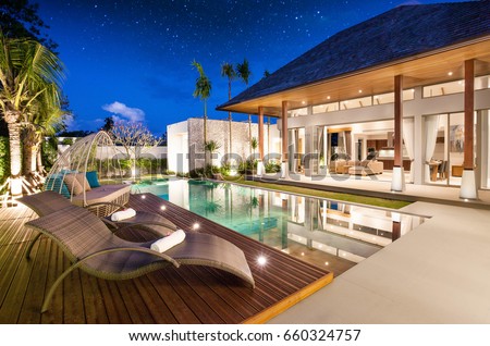real estate Luxury Interior and exterior design  pool villa with living room  at  night sky  home, house ,sun bed ,sofa ストックフォト © 