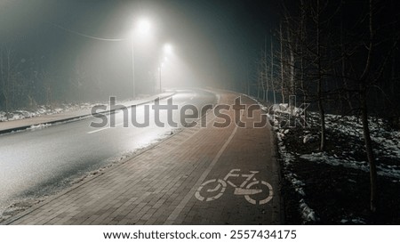 Similar – Foto Bild Radweg mit roter Fahrbahnmarkierung bei winterlichen Straßenverhältnissen.