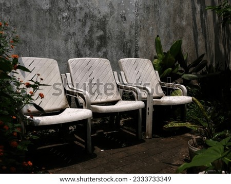 Similar – Image, Stock Photo White plastic garden bench stands on a meadow with yellow flowers