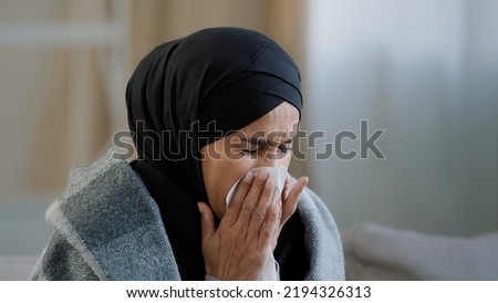 Similar – Image, Stock Photo Tired Arab woman wiping face with towel after training