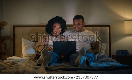 Similar – Image, Stock Photo Couple lying on bed and hugging in morning in nightwear