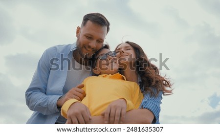 Similar – Image, Stock Photo Cheerful mom and son playing together in field