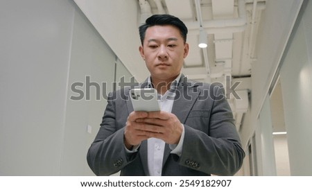 Similar – Image, Stock Photo Businessman browsing smartphone in city