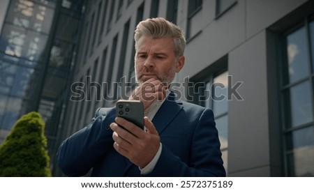 Similar – Image, Stock Photo Puzzled senior businessman in stylish formal wear at shopping plaza