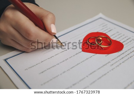 Hands of wife, husband signing decree of divorce, dissolution, canceling marriage, legal separation documents, filing divorce papers or premarital agreement prepared by lawyer. Wedding ring ストックフォト © 
