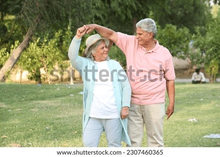 Similar – Image, Stock Photo Focused couple doing yoga in Awkward pose in park