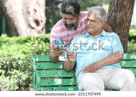 Similar – Image, Stock Photo Father and son using digital tablet together at night in bed