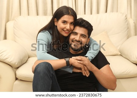 Similar – Image, Stock Photo Happy multiethnic lovers resting on sofa and kissing at home