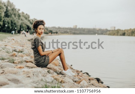 Similar – Image, Stock Photo Charming woman on stony coast