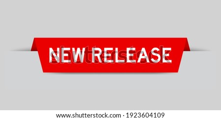 Red color inserted label with word new release on gray background