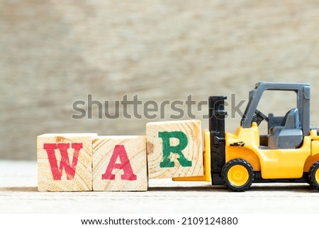 Toy forklift hold letter block R to complete word war on wood background Photo stock © 