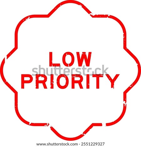 Grunge red low priority word rubber seal stamp on white background