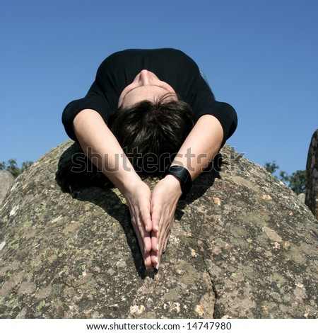 girl lying in a rock in moment of relax, meditation or faith - square format