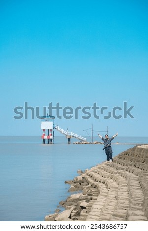 Image, Stock Photo Man stands with Frisian mink on the coast in the dunes