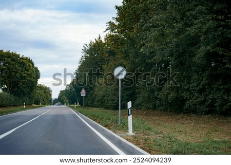 Similar – Image, Stock Photo Traffic sign prescribed driving direction straight ahead (traffic sign no. 209-30) partly covered with snow