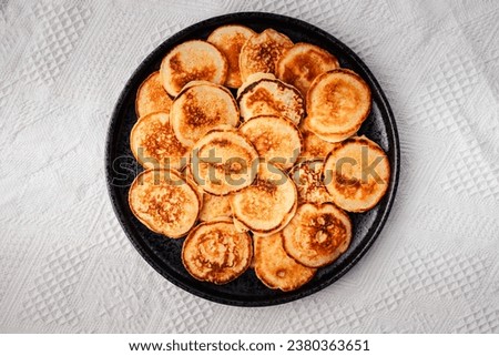 Image, Stock Photo Mini pancakes with butter and blueberries lie in a plate on a wooden table. Brunch, dessert for children, trending food. Space for text