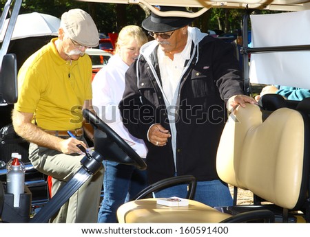 NEWPORT NEWS, VA- OCTOBER 25: Dennis Gage of My Classic Car signing a license plate in the 11th Annual Virginia Fall Classic in Newport News Park in Newport News, Virginia on October 25, 2013