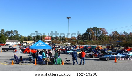 GLOUCESTER, VA- NOVEMBER 9: An Allstate insurance tent and the parking lot in the Shop with a Cop Car Show in Gloucester, Virginia on November 9, 2013