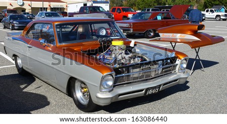 GLOUCESTER, VA- NOVEMBER 9: A two tone1966 Chevy Nova SS in the Shop with a Cop Car Show in Gloucester, Virginia on November 9, 2013