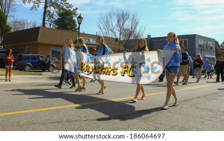 GLOUCESTER, VA - April 5, 2014: Gloucester County Baystars FC Soccer Club handing out candy, The Daffodil fest and Parade is a regular event held each spring