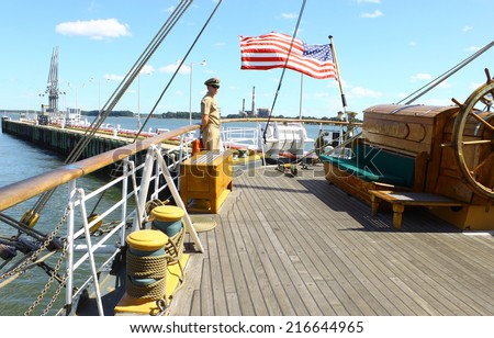 GLOUCESTER, VA - SEPTEMBER 6, 2014: An Eagle crew member watching the stern rudder control on the USCGC Eagle Barque at the Yorktown Coast guard training center on the York river in Virginia