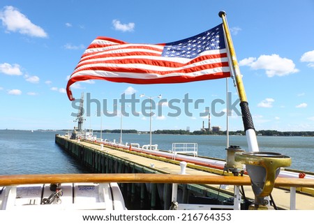 GLOUCESTER, VA - SEPTEMBER 6, 2014: The stern of USCGC Eagle with the American flag flying at the Yorktown Coast guard training center pier where it is tied up on the York river in Virginia