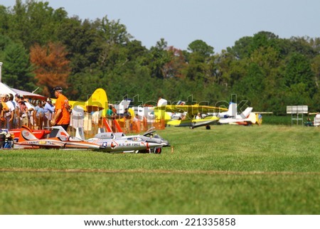 MIDDLESEX, VA - SEPTEMBER 27, 2014: Model airplanes in the grass at Hummel field airport in the wings wheels and keels annual show at the Hummel airfield airstrip in Middlesex VA